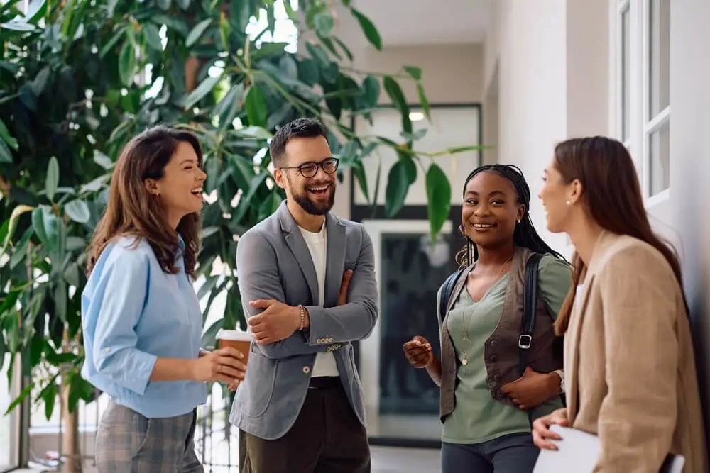Magnolia Alliance Royal team engaging in conversation indoors