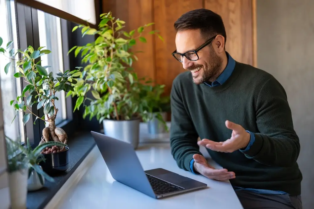 business professional engaging in a video call with plants in the background